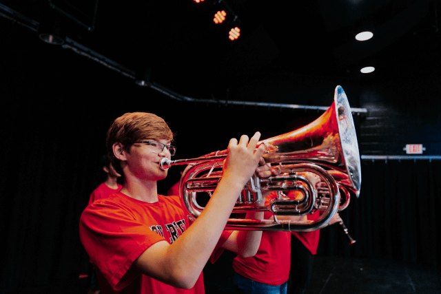 a child playing a trumpet